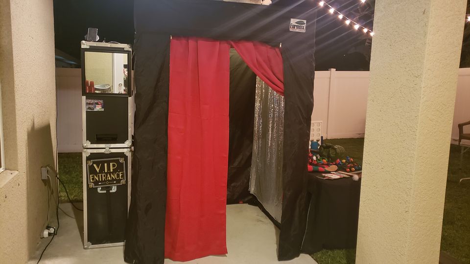 Enclosed booth with red velvet curtain and VIP lounge signage at a venue