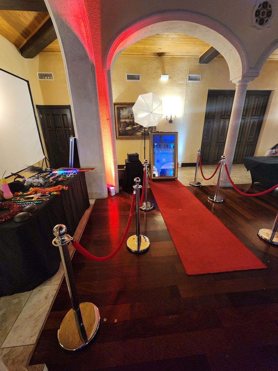 Magic Mirror glowing at a night event in a red-walled venue
