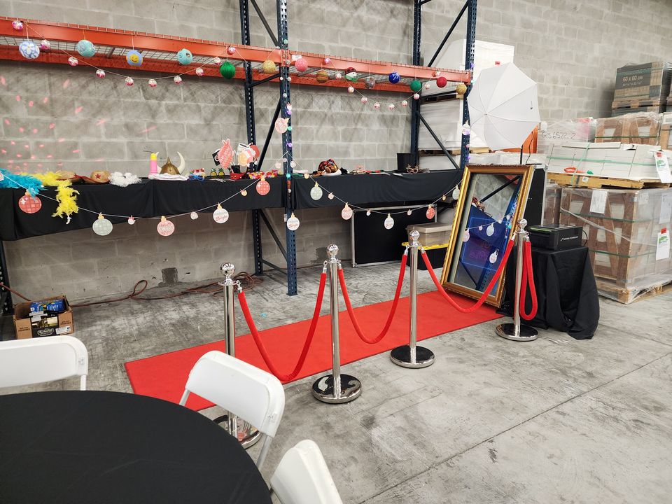 Magic Mirror set up at a warehouse holiday party with garland and stanchions