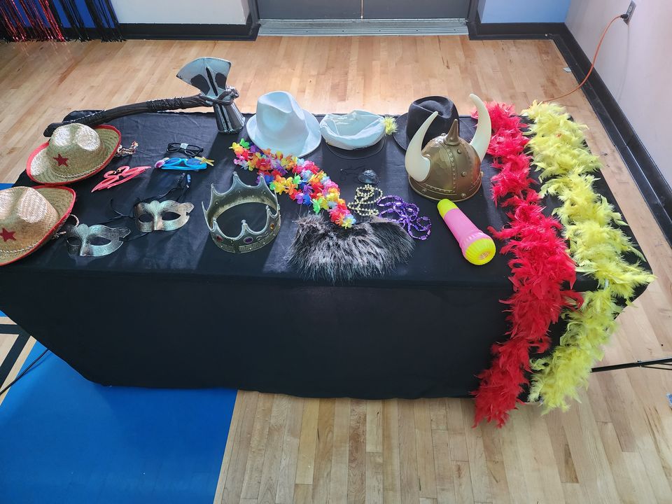 Props table with hats, boas and leis