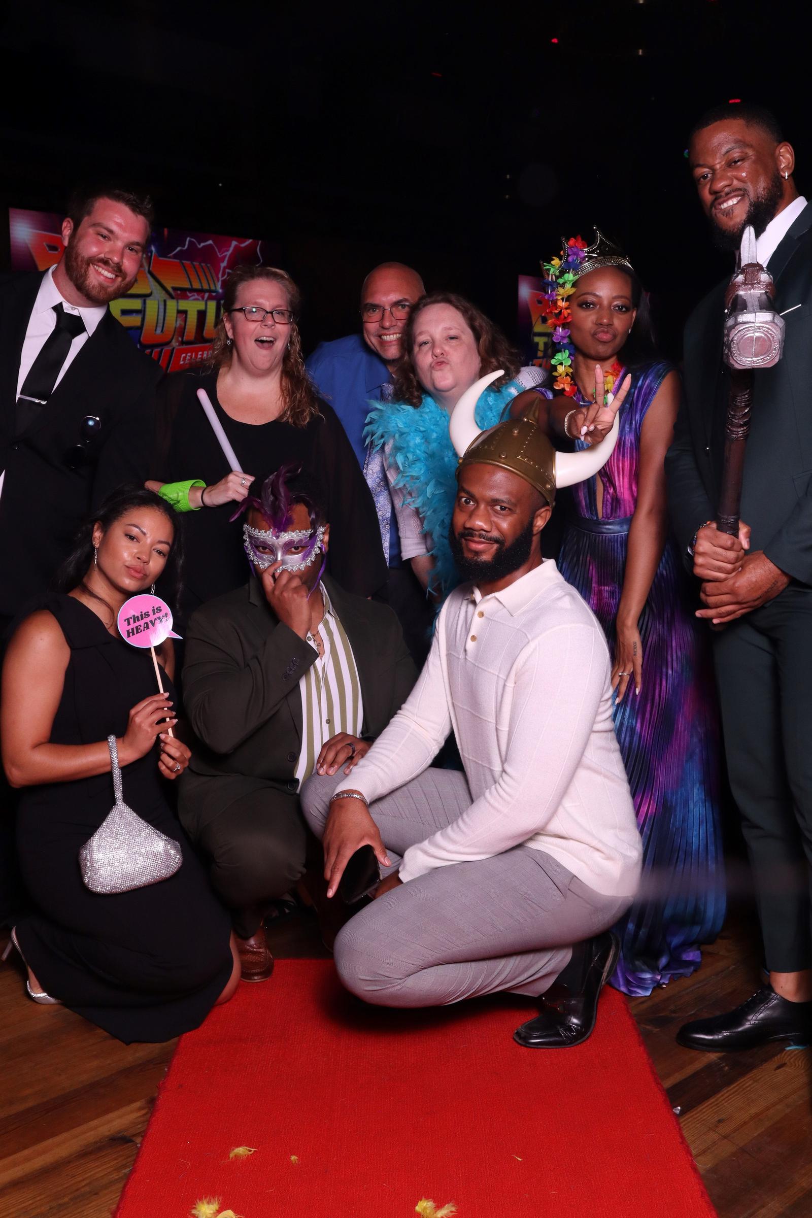 Guests posing with the Magic Mirror on the red carpet at a formal gala