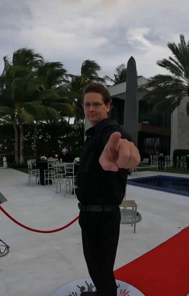 Josh on a selfie-station platform at a resort event with red carpet