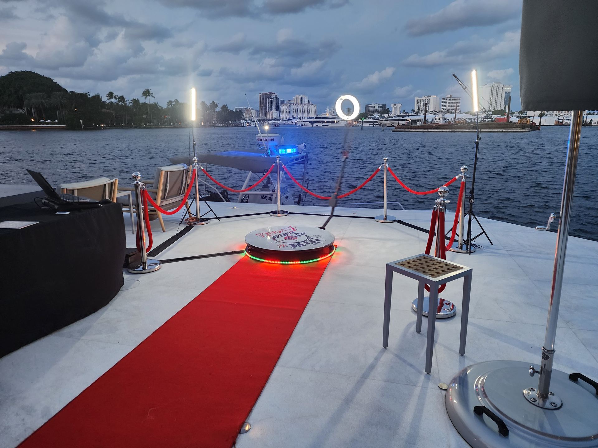 Platform 360 photo booth with red carpet on a waterfront event deck at night
